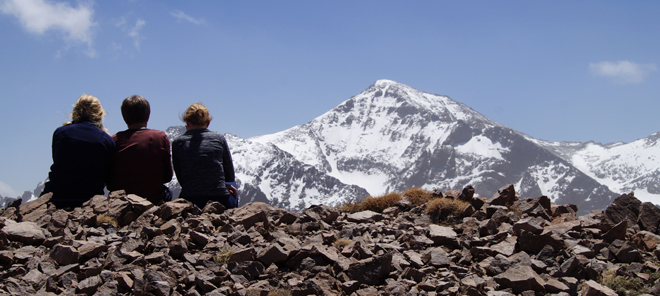 Three walkers looking at Mount Toubkal Atlas Mountains