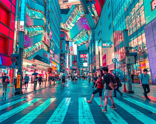 A bustling city street at night features people crossing, neon-lit buildings with reflective glass, and overhead glass tunnels. Japanese signage and advertisements are visible throughout, creating a vibrant, futuristic atmosphere.
